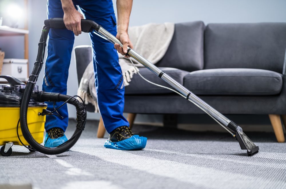 Carpet cleaners - carpet technician cleaning a carpet in a living room