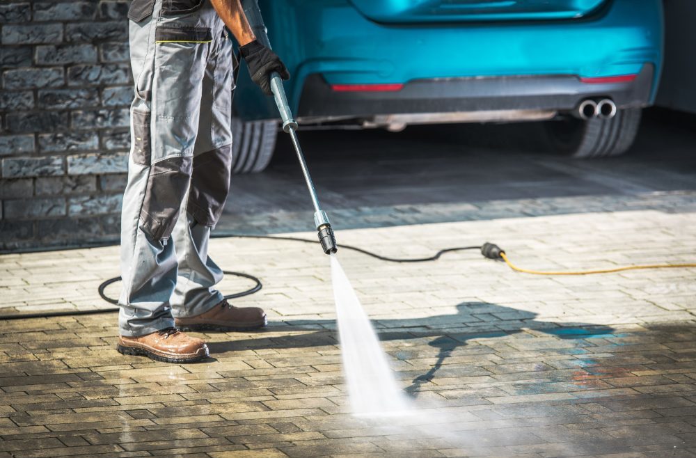 Contractor performing a driveway cleaning service