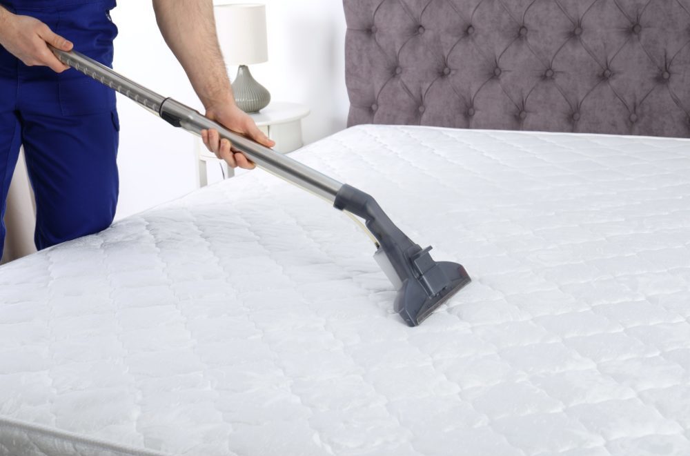 Mattress Cleaning - person vacuuming a mattress